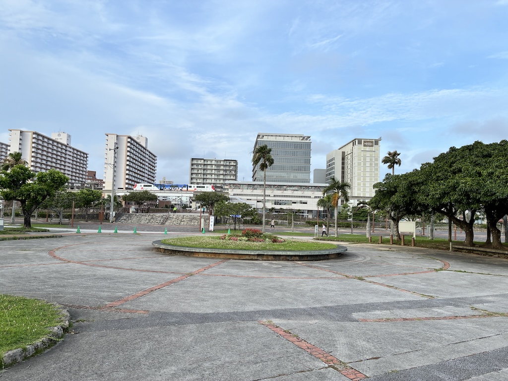 Naha cityscape under a clear blue Okinawa sky — modern Japan meets tropical scenery