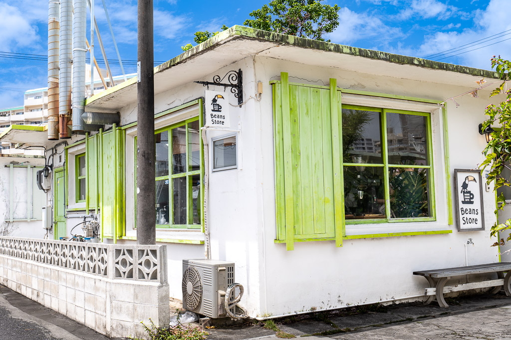 港川 (Minatogawa) Beans Store lime-green shutter solid-color facade — Okinawa Urasoe colorful Stateside town shop