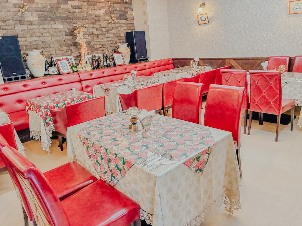 Pittsburgh Forum red leather sofas floral tablecloths retro dining room