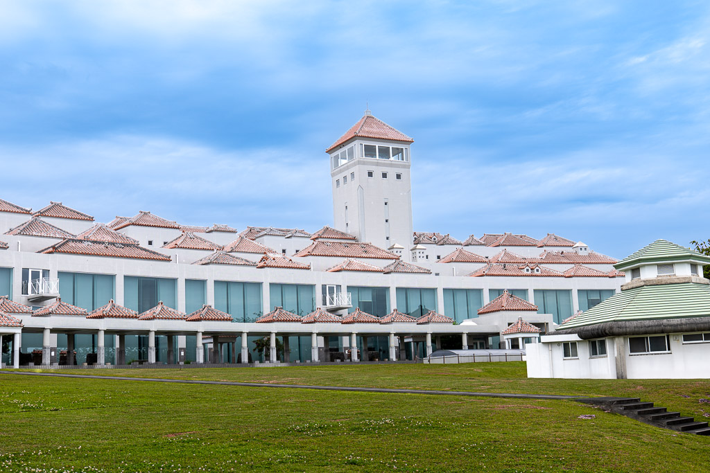 Wide view of Okinawa Peace Memorial Museum — Ryukyu red-tile colonnade with the Peace Memorial Hall tower behind