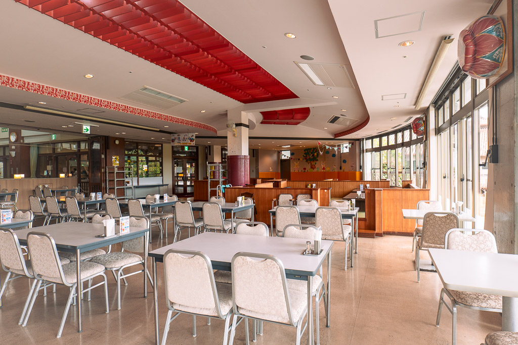 Okinawa World restaurant — Ryukyu red-tile ceiling with neat dining tables inside
