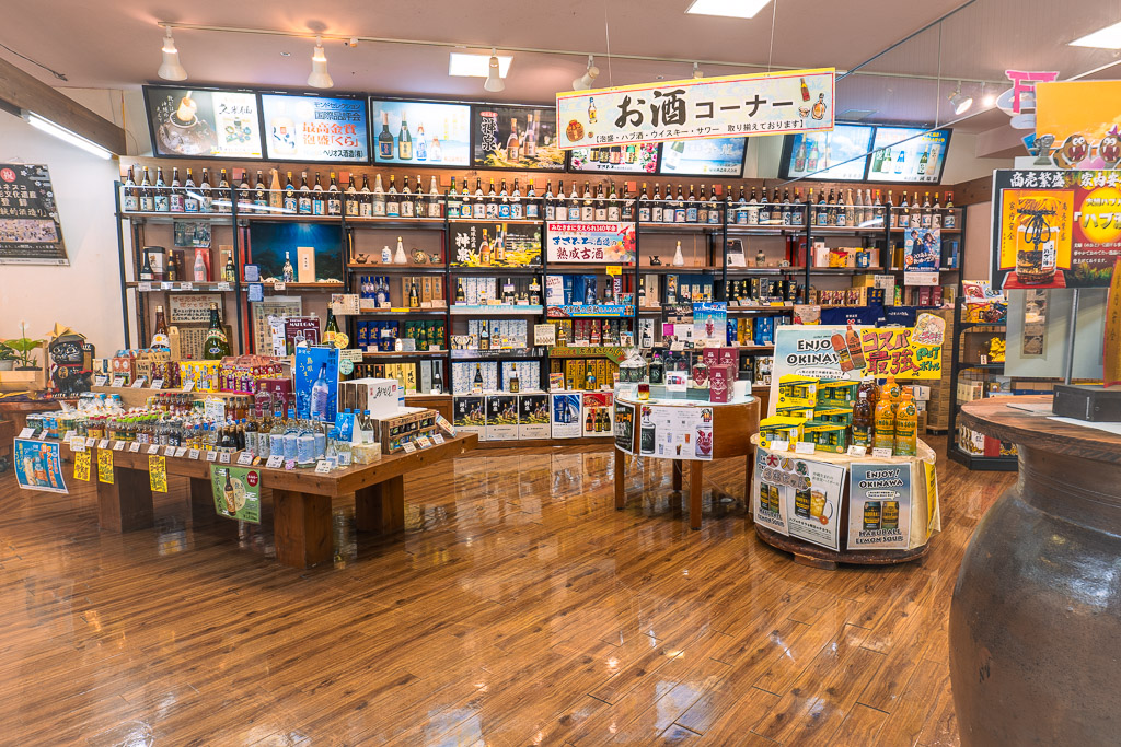 Okinawa World liquor corner — awamori, Orion beer and habu sake on shelves