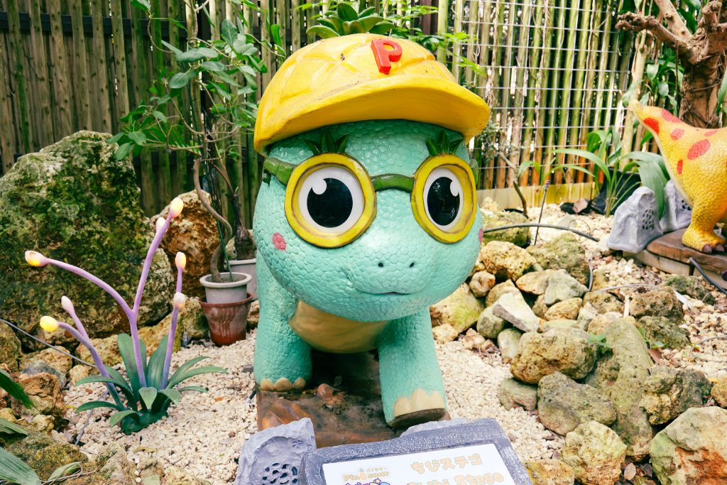 Yellow-helmeted turtle mascot character at Nago Pineapple Park