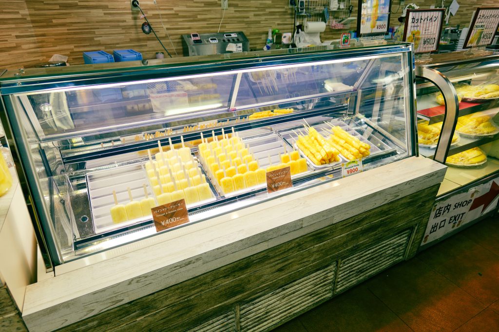 Pineapple ice pops and skewers display at Nago Pineapple Park Okinawa