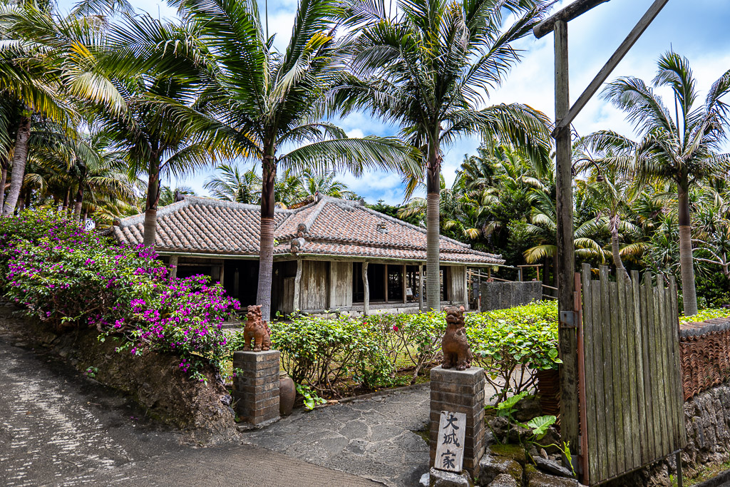 Former Oshiro House — traditional Ryukyuan kominka with red-tile roof and limestone walls