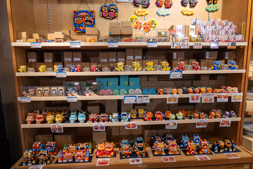 Ryukyu Village Shisa shelf with hundreds of colorful Shisa figurines lined up on display
