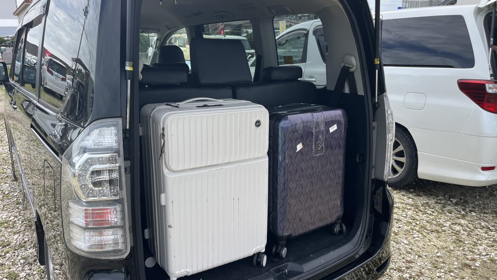 Toyota Voxy trunk — 3rd row deployed, suitcases stacked