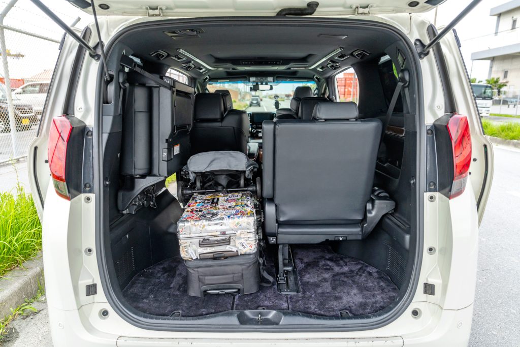 Toyota Alphard trunk — 3rd row half-folded, mixed suitcase loadout