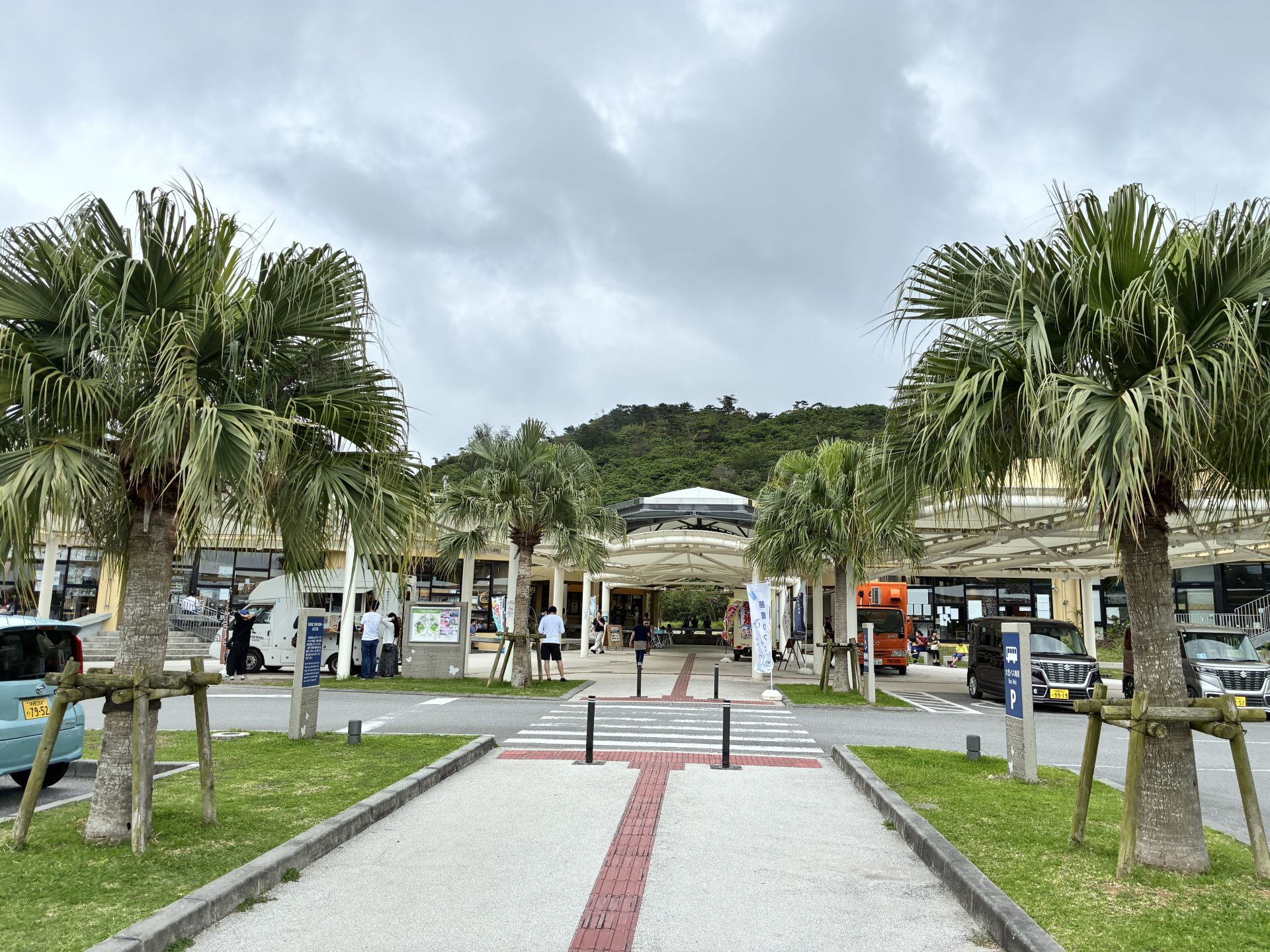 Cloudy sky over a roadside station with palm trees