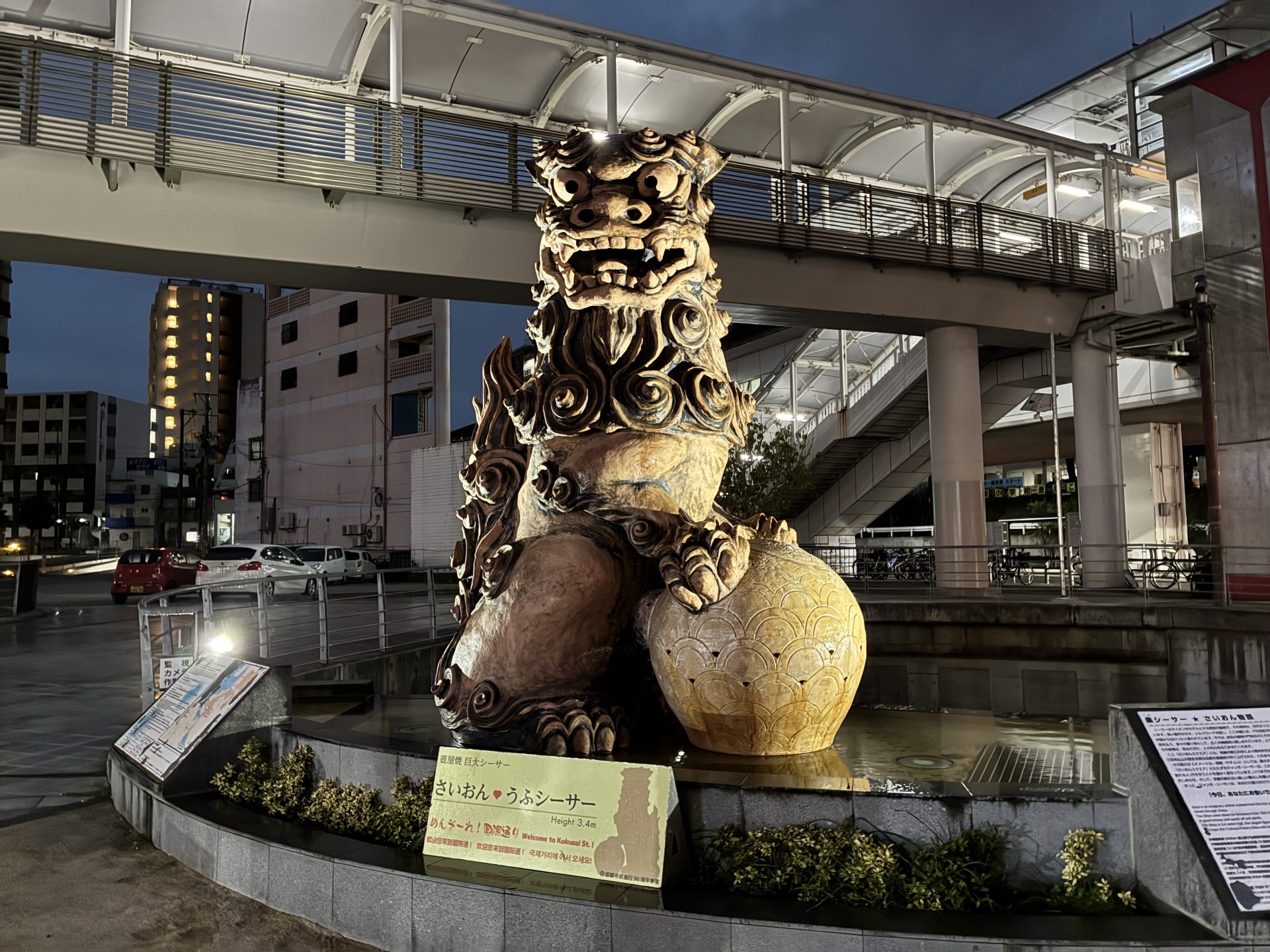 Kokusai-dori at night with shisa lion sculpture
