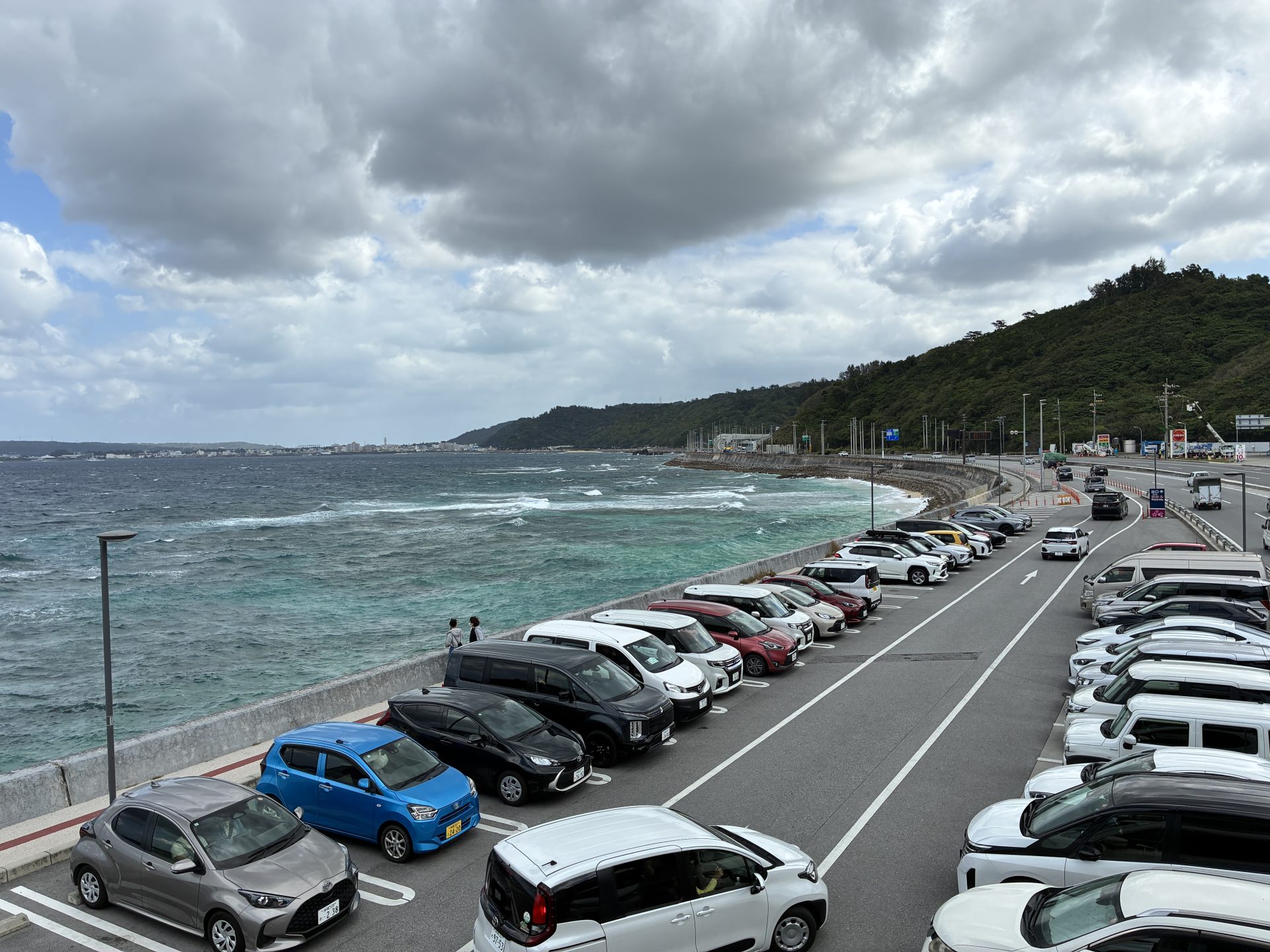 Coastal parking lot full of rental cars on a cloudy Okinawa day