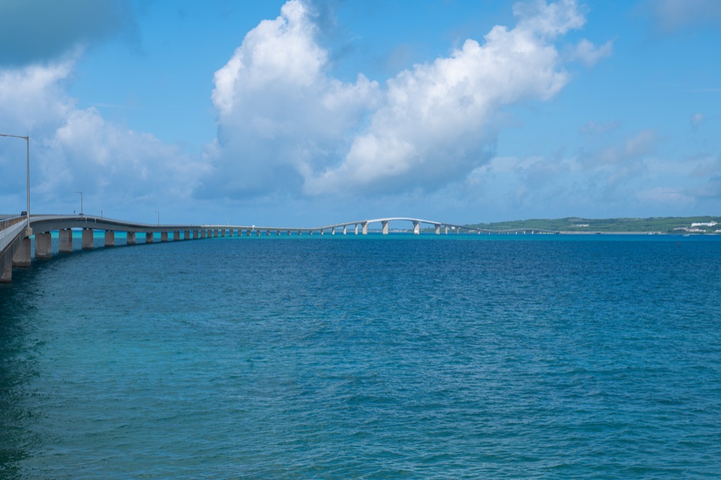 Wide view of Irabu Ohashi Bridge showing the central arch over deep blue water