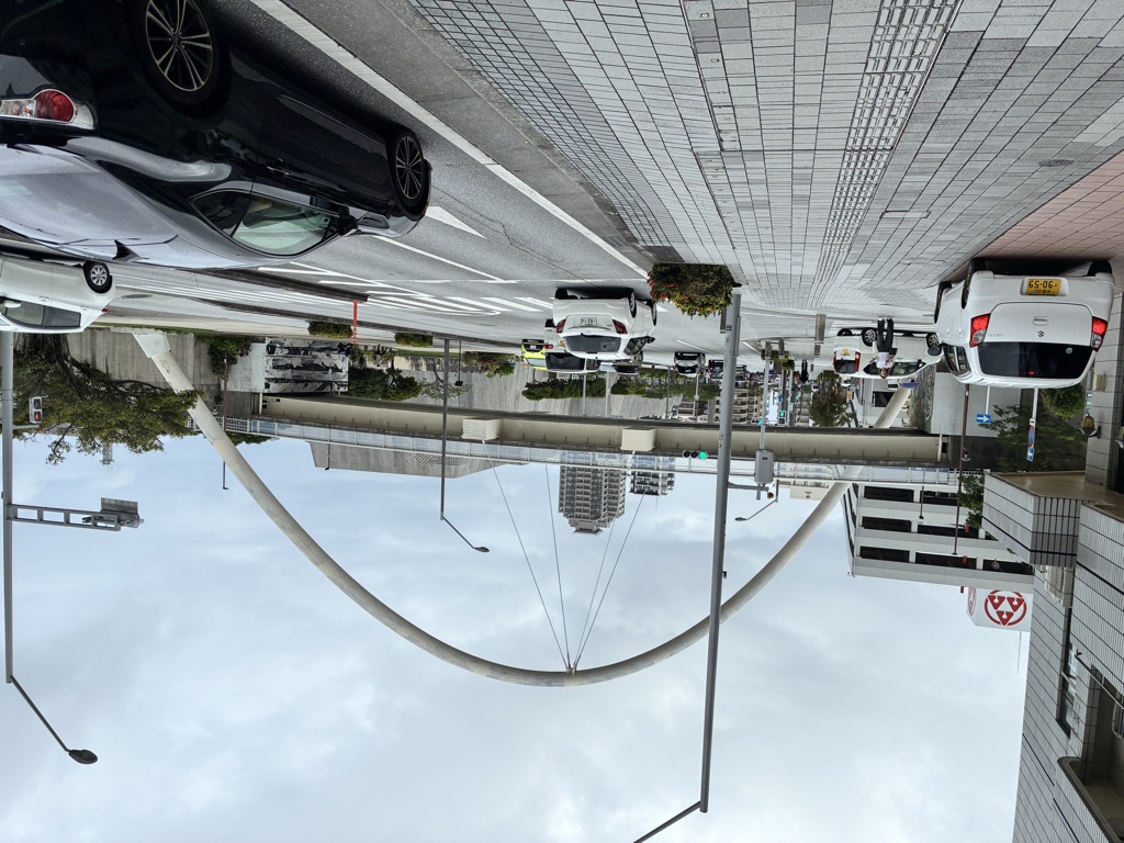 Japanese coin parking lot with metal flap lock plates and rental cars