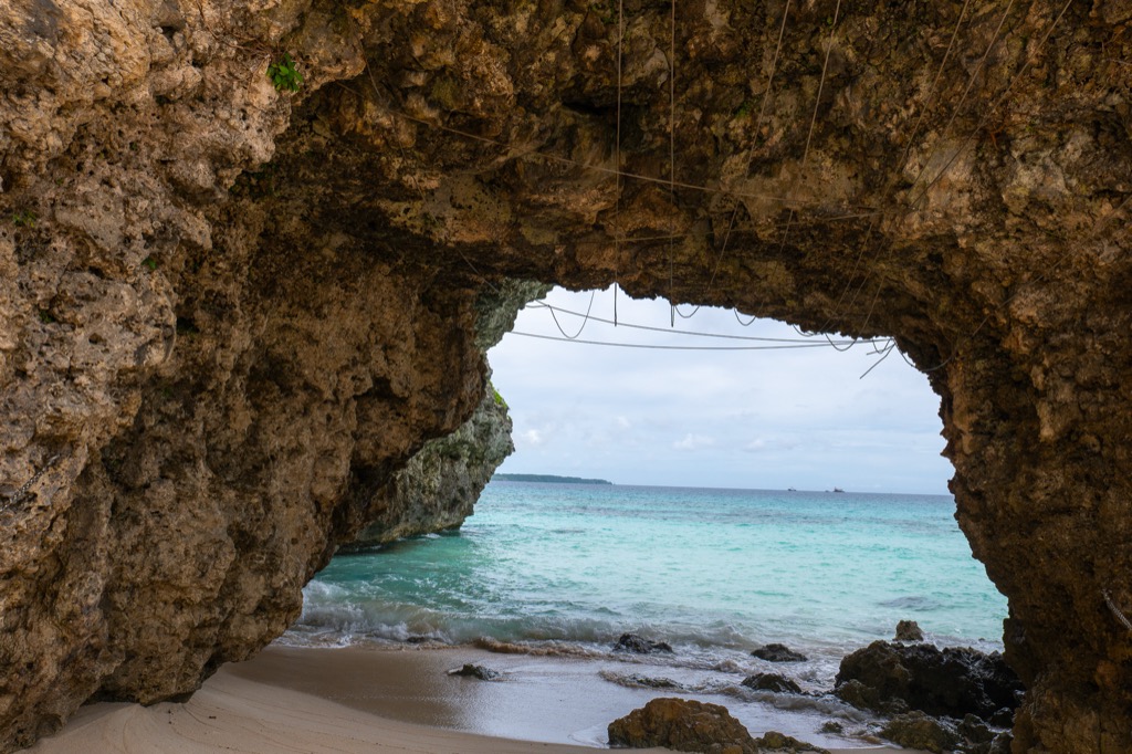 The natural arch rock at Sunayama Beach Miyakojima framing turquoise Miyako Blue sea