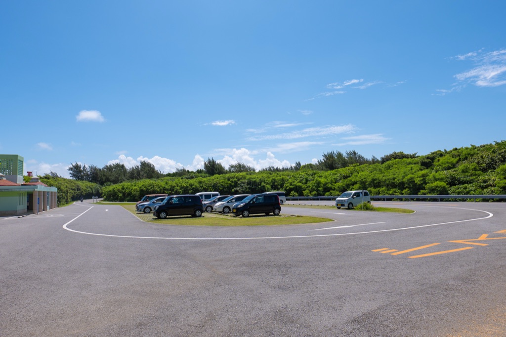 Toriike Pond free parking lot on Shimoji Island under a bright blue Miyakojima sky