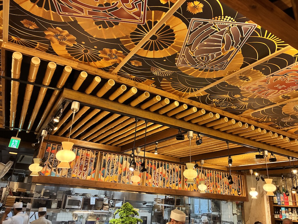 Hand-painted Ryukyu paper-umbrella and crab motifs on the wooden ceiling of Umi no Chinbora