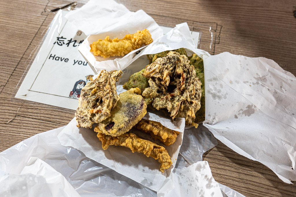 Freshly fried Oshiro Tempura — aosa sea lettuce, fish, beni-imo on white paper