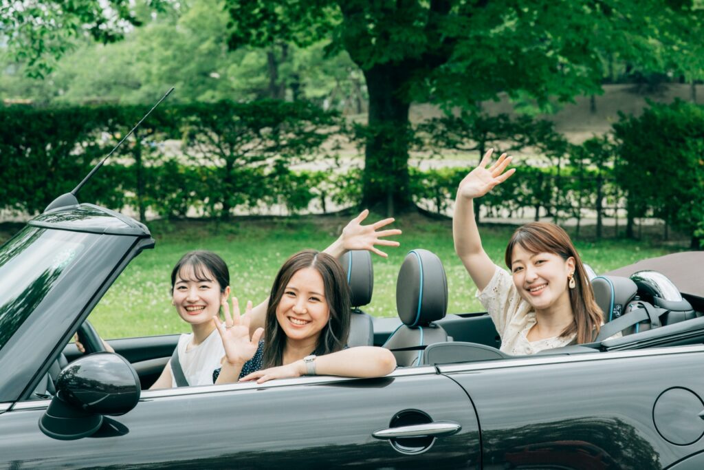 Friends enjoying a convertible rental car in Okinawa