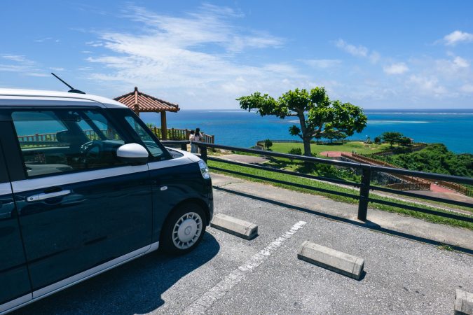 Rental car parked at a scenic Okinawa ocean overlook