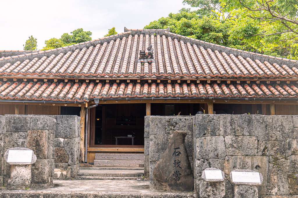 Ryukyu Kingdom Village — a 100-year-old Okinawan red-tile house with stone walls and steps