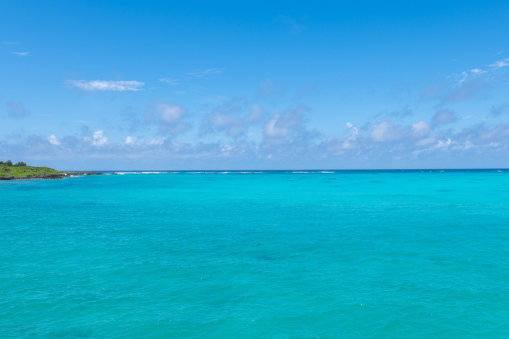 Wide turquoise horizon at 17END with a few small clouds in a clear sky