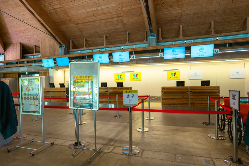 Shimojishima Airport check-in area with multilingual signs and minimalist wooden architecture