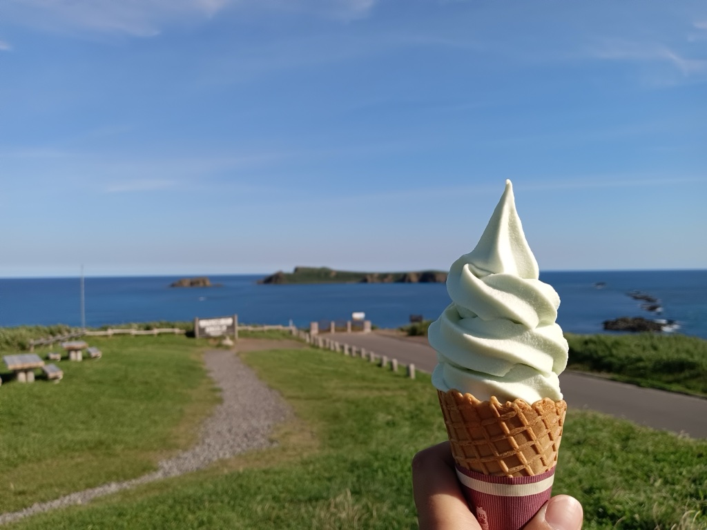 Sukoton Cape signpost — Japan's northernmost reachable cape and the offshore Todo Island silhouette