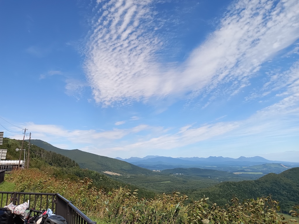 Karikachi Pass in September — wide blue sky and layered mountain ridges of central Hokkaido