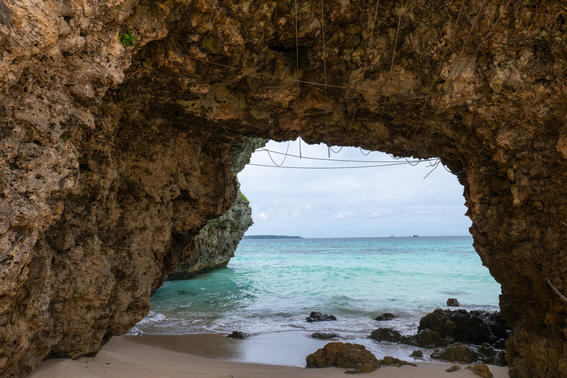 Sunayama Beach Miyako Island — natural rock arch carved by waves, quiet sunset spot