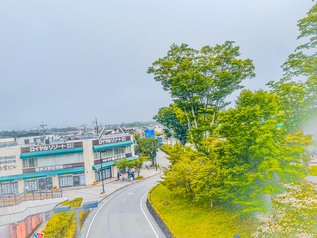 Elevated view over the Royal Resort building and green trees in Karuizawa town