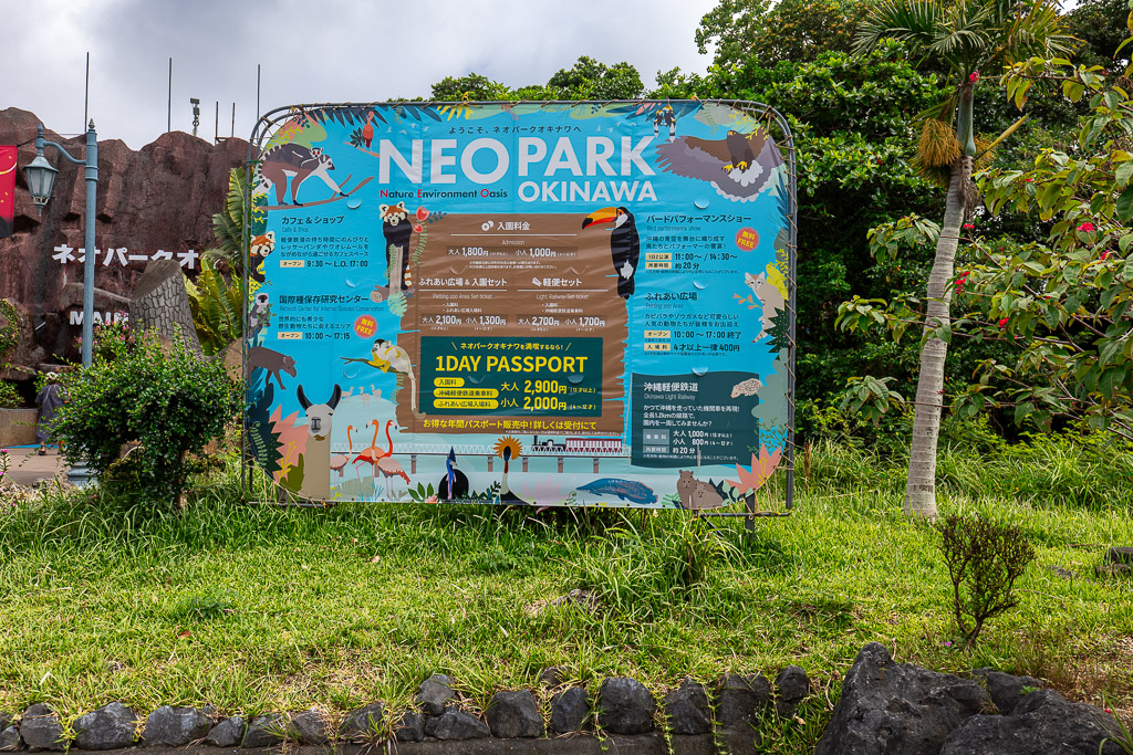 Neo Park Okinawa admission sign showing 1DAY PASSPORT pricing at the entrance