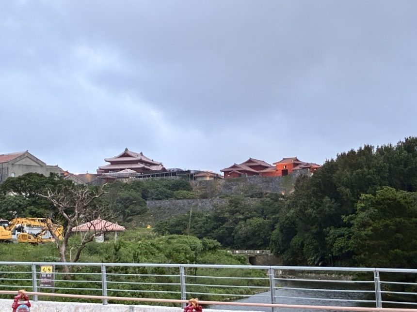 Shuri Castle's scarlet Seiden main hall on the hilltop above Naha at dusk, Okinawa