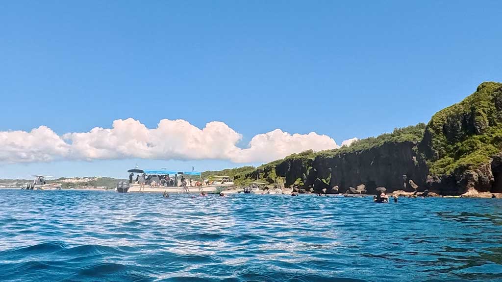 Snorkelers descending the Cape Maeda staircase to the Blue Cave entry point