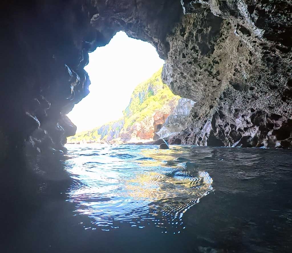 Snorkeler wearing mask and fins in the water at Okinawa Blue Cave