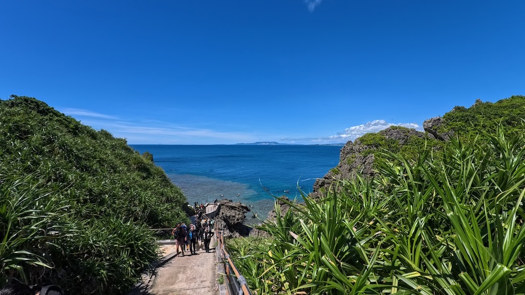 Instructor-shot photo of snorkeler in Okinawa Blue Cave with fish