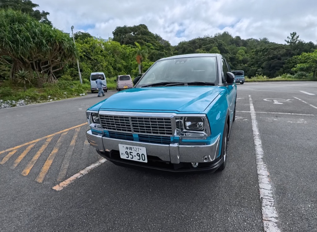 Compact SUV rented in Okinawa (Daihatsu Rocky, light-blue) — an actual rental car with additional drivers registered so travelers can share driving on their Japan road trip