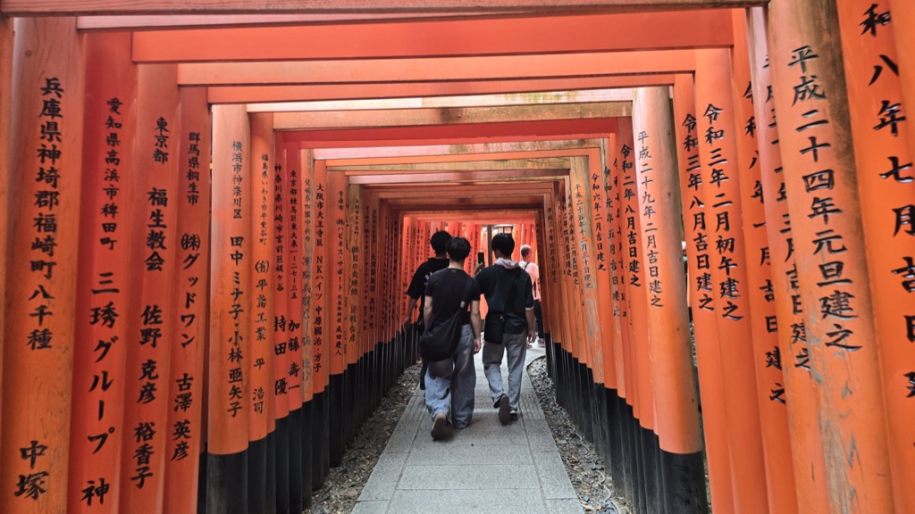 Fushimi Inari Taisha approach street storefront with fox masks vermilion red curtain and Kogitsune Ice cream display
