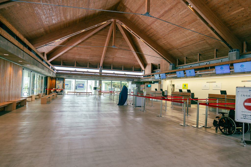 Shimojishima Airport terminal interior with wooden beam ceiling and check-in counters