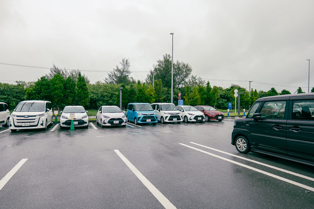 Miyakojima rental car lot with a variety of vehicle types from kei cars to minivans