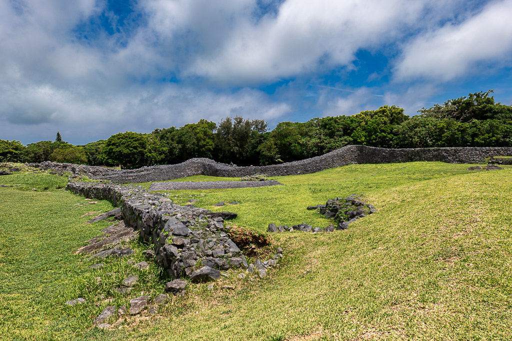 Ryukyu-style low stone walls curving across the grass fields of Nakijin Castle Ruins