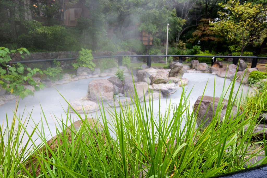 Steamy rooftops of the Kannawa onsen town at dusk