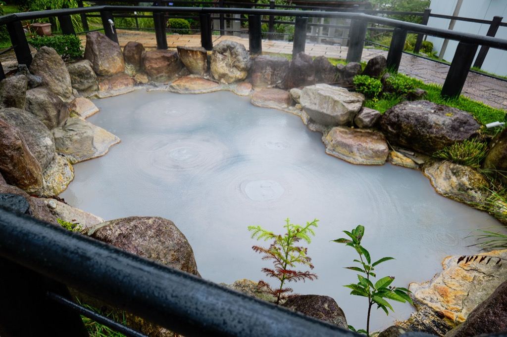 Grey bubbling mud pools of Oniishibozu Jigoku