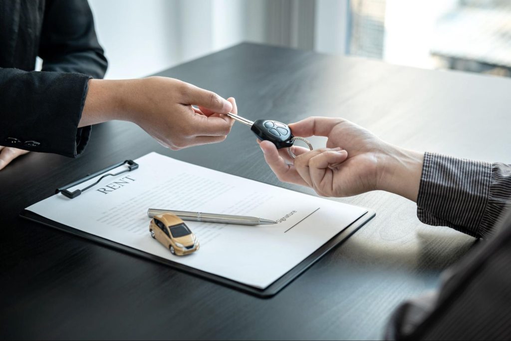 Rental car key handover at a counter in Hokkaido