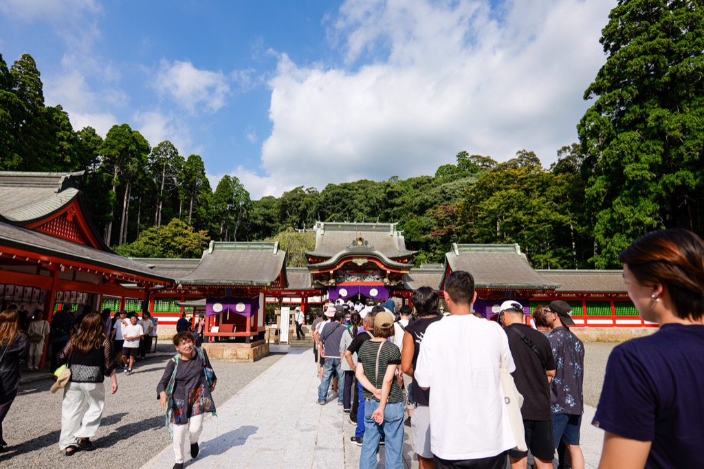 Red shrine buildings surrounded by forest at Kirishima Jingu