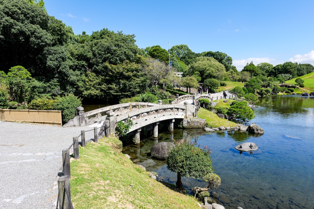 Stone bridge and pond at Suizenji Jojuen Garden
