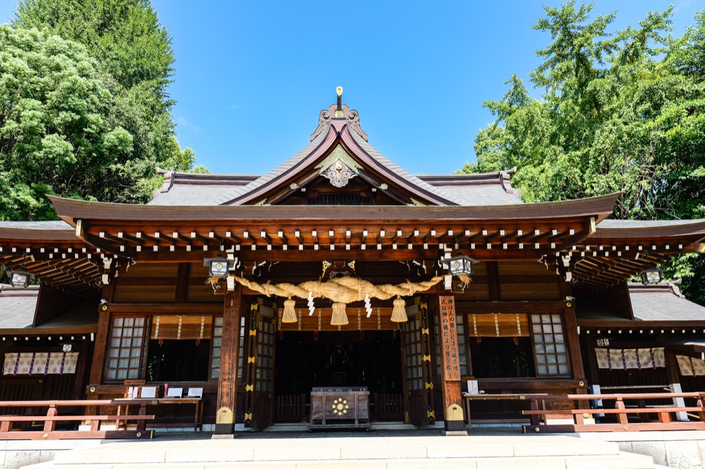 Wooden main building of Izumi Shrine under a blue sky