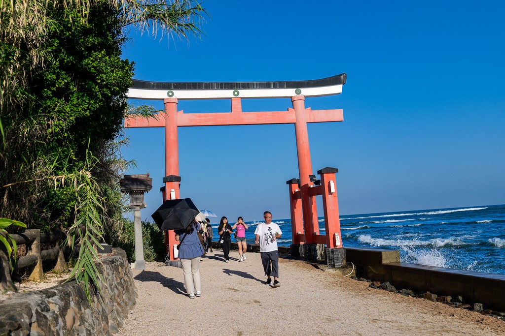 Red torii beside the sea