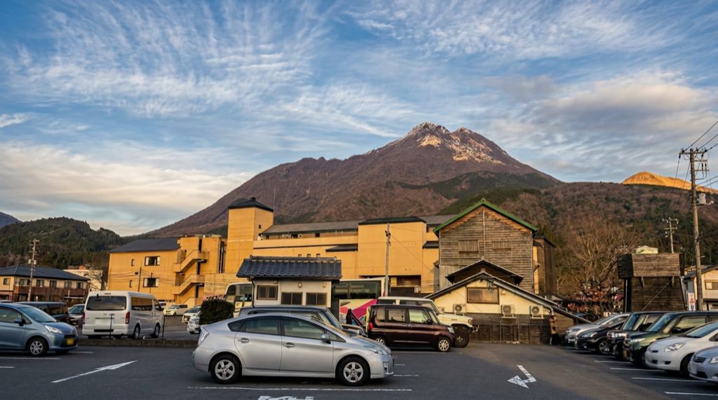 View of Mount Yufu (由布岳) from Yufuin town — the twin peaks looming over hot spring rooftops define the Oita skyline