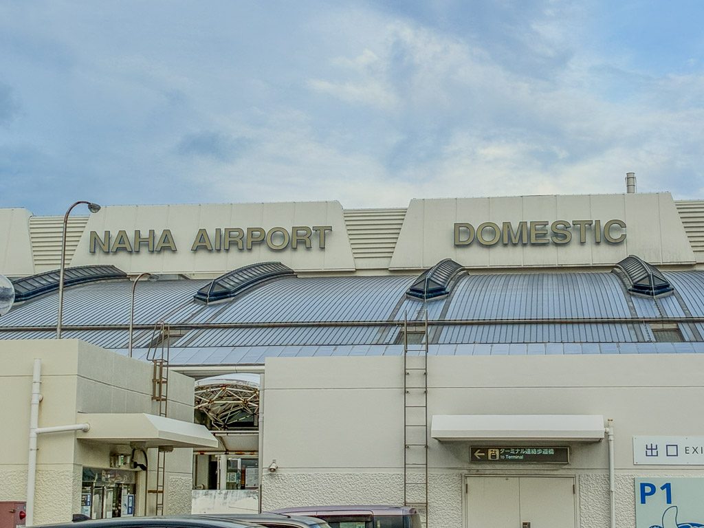 Traveller heading from Naha Airport arrivals to the taxi rank