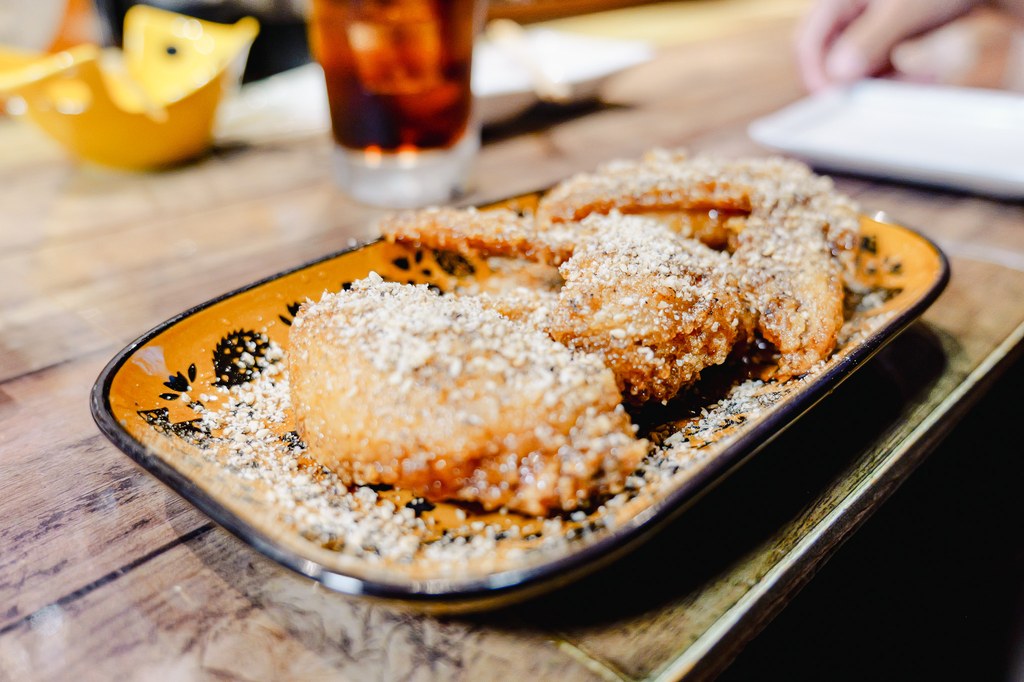 Sesame-fried appetizer on the counter of a Yufuin izakaya